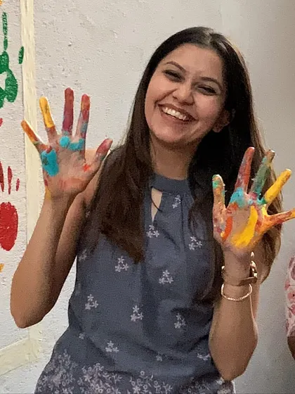 Me, showing off my colorful hands during the handprint mural project. It’s impossible not to get involved in the fun.