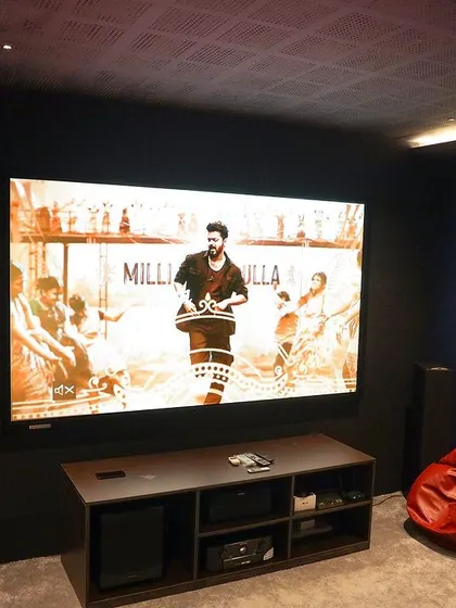 This shot includes a red bean bag, showing how I add flexible and fun seating options to a more minimalist theater design.