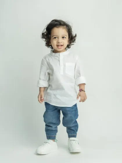 A full-length shot of the little boy, showing off his charming personality.