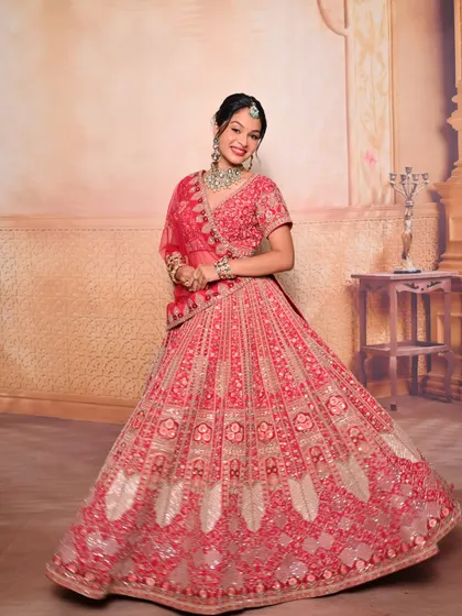 A beautiful full-length shot of a student's portfolio work, showcasing a complete bridal look with a stunning red lehenga.