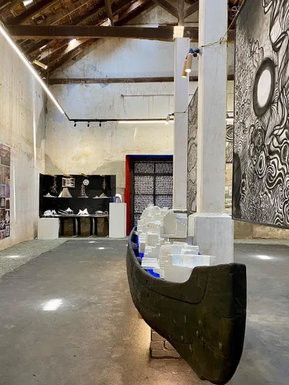 The exhibition space at SEED Kochi, featuring a large boat sculpture and student projects. The school's environment is charged with creative energy and a commitment to exploring new possibilities in design education.