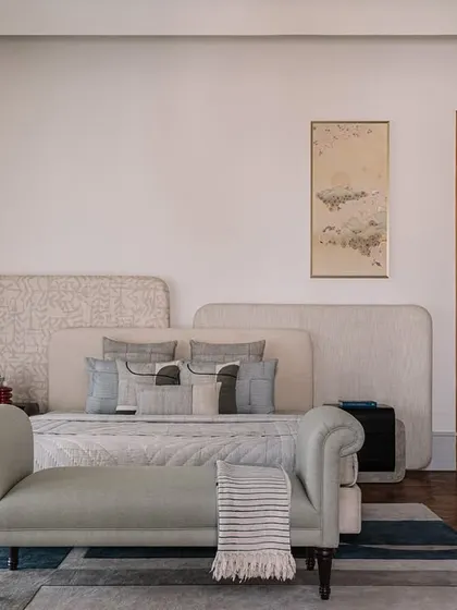 The master bedroom at Rehethaan, featuring a custom headboard and a serene color palette. The space is designed to be a calm and restful retreat.