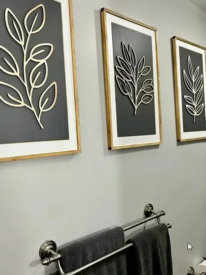 This set of three wood leaf wall art pieces is perfect for a bathroom or any space needing a touch of green. Each panel features a different leaf design for a varied yet cohesive look.