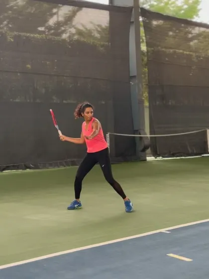 Yashi demonstrates her powerful forehand during a practice session. It is this level of intensity in training that translates to victories in competitive tournaments.