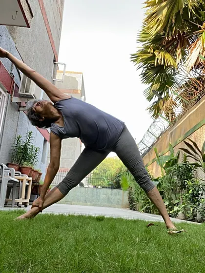 A deep side stretch in the garden. This variation of Triangle Pose focuses on lengthening the spine and opening the side ribs to improve breathing capacity.