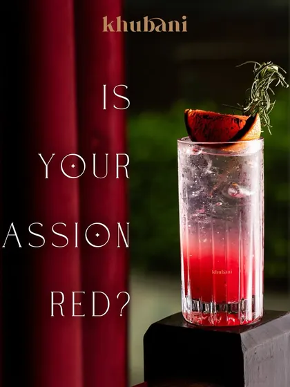 Is your passion red? This striking cocktail, garnished with charred citrus and rosemary, is not just a drink, it's an experience.