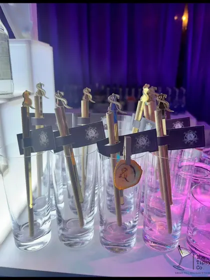 Customization is key. These glasses are set up with personalized stirrers and tags, ready for a night of bespoke cocktails and celebration.