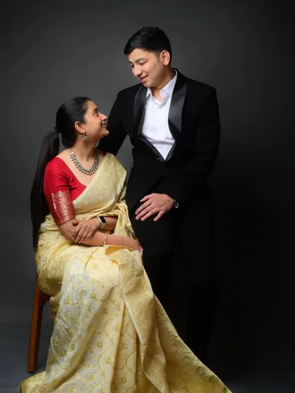 A seated version of the formal pre-wedding shoot. The loving gaze between the couple is the central focus of this romantic portrait.