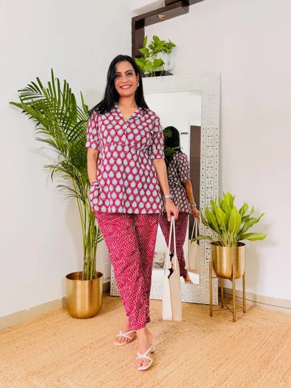 A lovely printed co-ord set in shades of pink. The short-sleeved peplum top is very flattering and the matching pants complete the look.