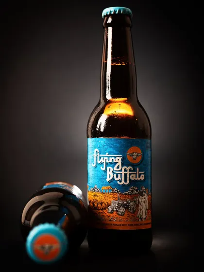 A creative product shot of a beer bottle with dramatic lighting. This style helps a brand stand out from standard e-commerce photos.