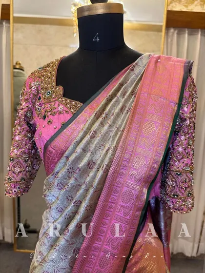 The full view of the pink bridal blouse on a mannequin, paired with a silver and pink Kanjivaram saree. The combination is absolutely breathtaking.