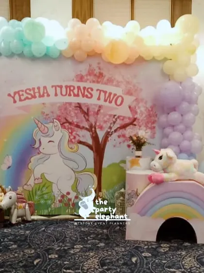 A closer look at the main photo area for the unicorn party. The backdrop, with its gentle rainbow and cherry blossom tree, was designed to be a perfect spot for capturing birthday memories.
