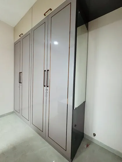 Another angle of the grey wardrobe, showing the seamless integration of the dressing unit and the overhead loft storage.