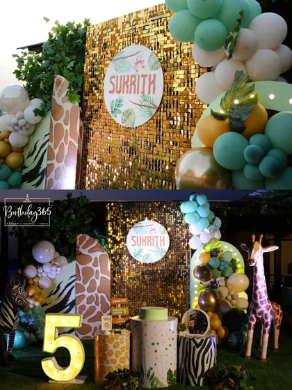 A detailed look at the jungle safari setup for Sukrith's 5th birthday, featuring a gold sequin backdrop and animal-print decor.