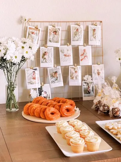 A beautiful way to display cherished memories. This photo grid showcases pictures of the baby's first year, creating a personal and heartwarming detail for the first birthday celebration.