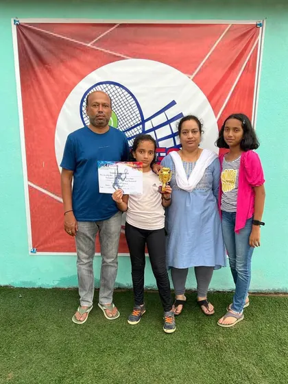 Ashvika with her family and her trophy.