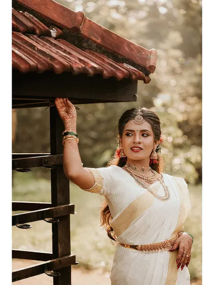A stylish portrait of the bride posing by a traditional structure.