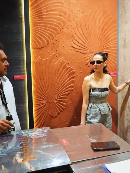 The stunning Mandana Karimi visited our booth at the Ajio Luxe Weekend, seen here admiring our sculptural, terracotta-toned 3D wallcovering.