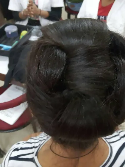 This multi-bun updo was created during a classroom session. Students work at their own stations, allowing them to build muscle memory and perfect their technique through daily practice.