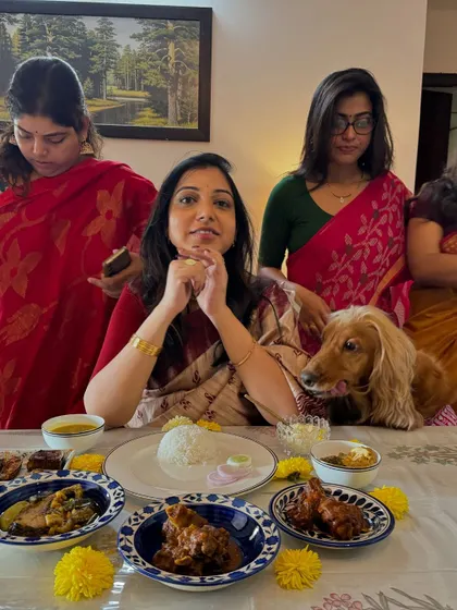 Enjoying the delicious spread at my Bengali Saadh, with Posto hoping for a taste.