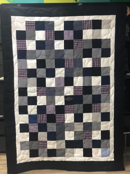 A classic checkerboard memory quilt made from a collection of men's shirts. The simple pattern allows the different fabrics and memories associated with them to take center stage.