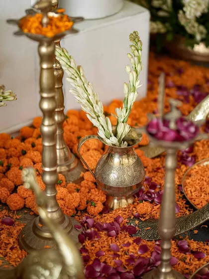 Floral details for a haldi, where traditional brass diyas, marigolds, and tuberoses come together in a beautiful cultural blend.