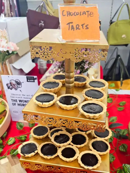 A three-tiered stand filled with our decadent chocolate tarts. These bite-sized desserts are a perfect addition to any grazing table or dessert spread.