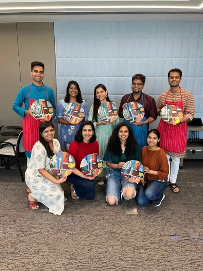 A proud group from the Google team showcasing the unique city-themed artworks they created during our workshop. Each piece reflects their individual style and creativity.
