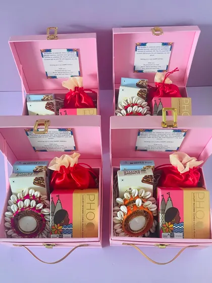 Our pink suitcase boxes are a popular choice for a softer, more cheerful aesthetic. Here they are, ready for a bulk order, filled with festive goodies.