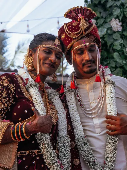 This candid shot from a Maharashtrian wedding captures the beautiful, unscripted moments between the couple. We believe these quiet, happy exchanges are just as important as the main rituals, adding a layer of authenticity to your wedding story.