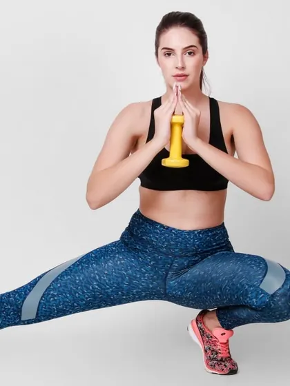 For activewear and fitness brands, I shoot dynamic poses that highlight the functionality of the clothing. This image shows a model in a sports bra and leggings performing a side lunge, perfect for a fitness apparel banner shoot.