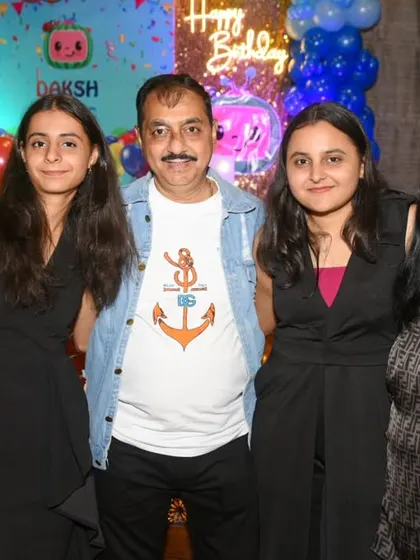 A happy family group enjoying the birthday celebrations.