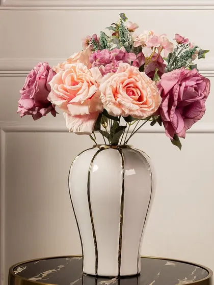 This beautiful bouquet of artificial peonies and roses in shades of pink and peach is perfect for a romantic and classic floral arrangement. They look stunning in a simple white ceramic vase.