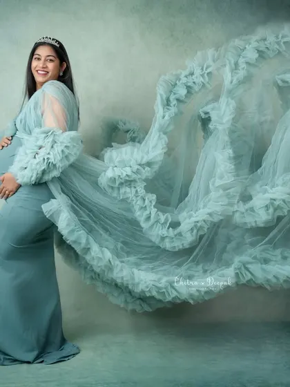 We love creating dynamic, breathtaking images. By tossing the fabric of this stunning ruffled gown, we add a sense of movement and magic to this maternity portrait.