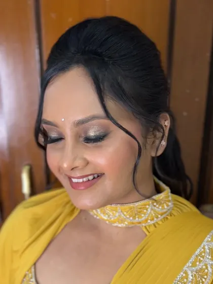A modern, pre-pleated yellow saree look. The draping is sharp and contemporary, perfect for a Haldi ceremony or a sangeet party.