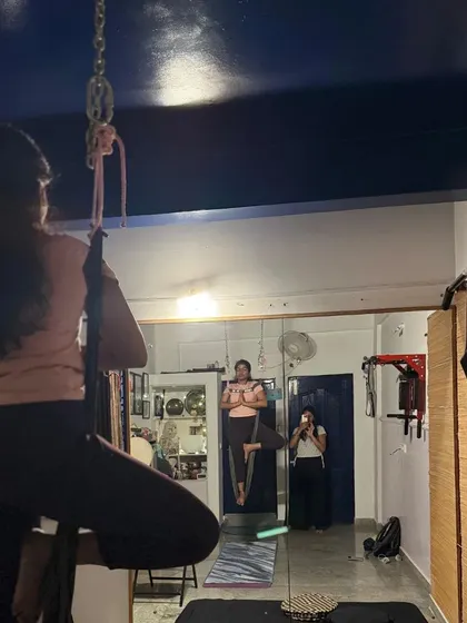 A view from my studio of students practicing Tree Pose (Vrksasana) in the aerial hammock. The silk adds a new challenge to this classic balancing posture.