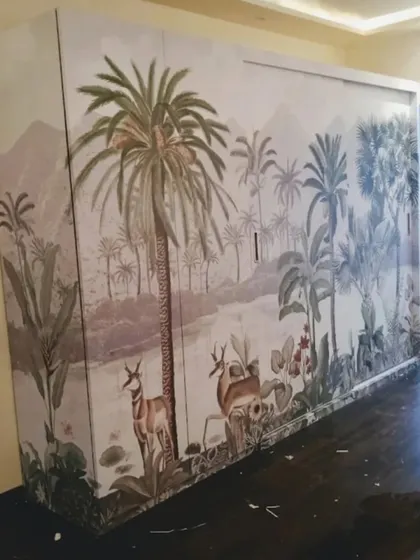 Our custom wallpapers can even be applied to furniture. Here, a large wardrobe is transformed with a beautiful tropical landscape mural.