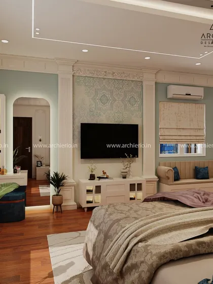 A luxurious master bedroom with a built-in window seat, perfect for relaxing with a book. The design uses classic pillars and soft blue-green tones to create a serene and elegant retreat.