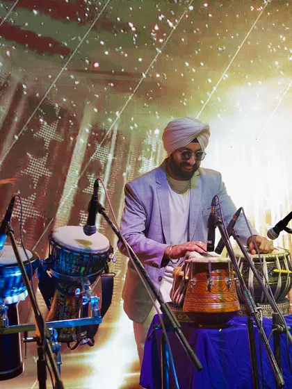 Playing the djembe against a starry background projection. We use visuals to enhance the musical experience.