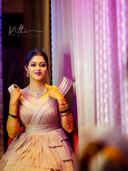 A portrait of our gorgeous bride Akshatha, ready for her cocktail party in a custom shimmer rose gold gown.