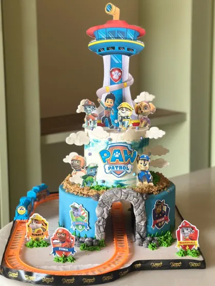 This pup-tastic Paw Patrol cake is ready to roll into the paw-ty. Featuring the iconic lookout tower and a working toy train track, it's a cake that's as fun to play with as it is to eat.
