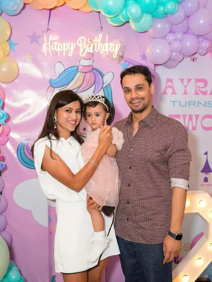 A beautiful family portrait at a unicorn-themed 2nd birthday party.