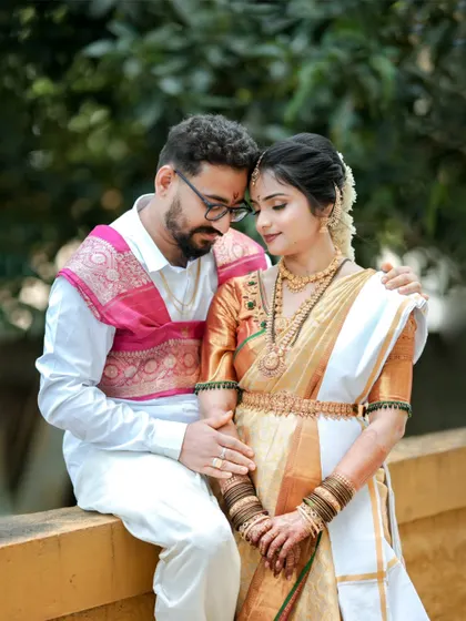 An intimate portrait of a couple, the groom's arm around his bride, as they share a quiet moment on their wedding day.