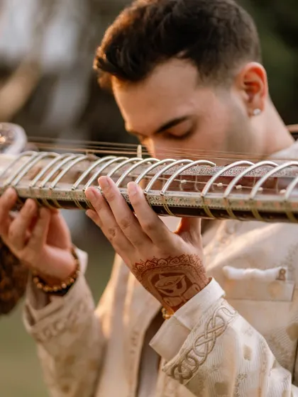 A close-up on my hands, showing the henna detail before the India tour.