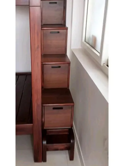 The staircase of the bunk bed, where each step is also a functional drawer. This is a perfect example of our commitment to creating smart, space-saving furniture for kids' rooms.
