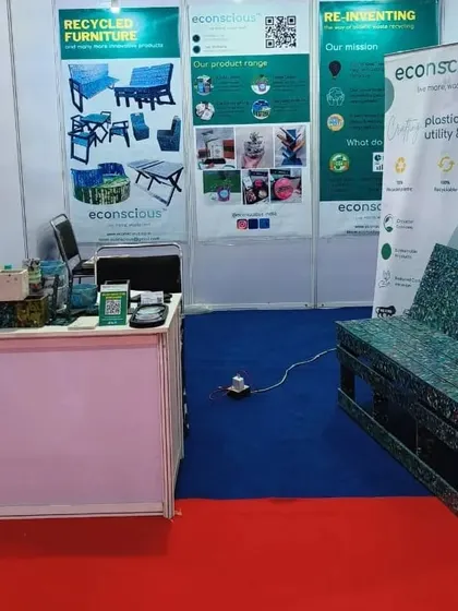 Our exhibition stall featuring one of our signature benches made from multi-colored recycled plastic. These benches are not just products; they are conversation starters about the potential of waste.