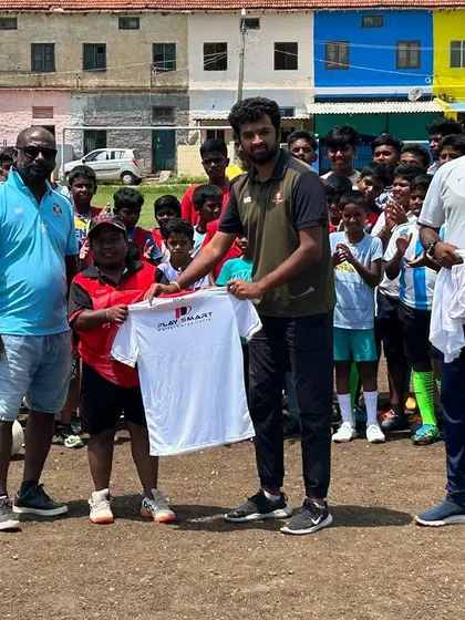 A special moment at the KGF Champion Grounds, as a young player is presented with a Playsmart jersey.