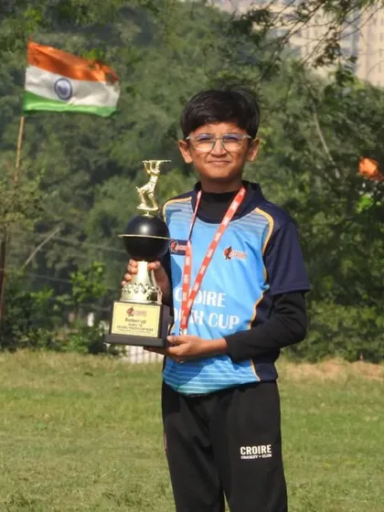 A proud moment for a young achiever at the Croire Youth Cup. The Indian flag in the background adds to the sense of pride.
