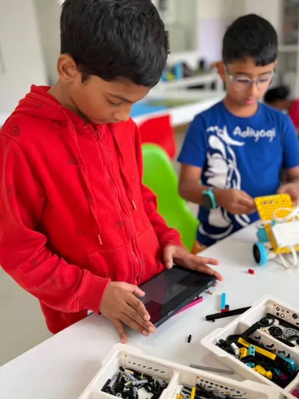 A student uses a tablet to program his team's robot for the IRO 2025. This process of coding and testing is a core part of our training, building both technical skills and patience.