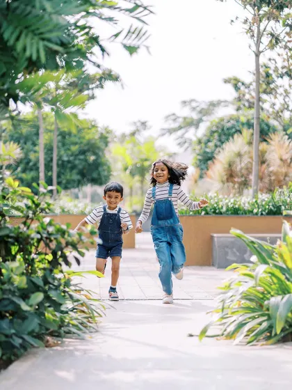 Siblings running hand-in-hand, full of energy and joy. My sessions are about letting kids be kids, and capturing their natural connection through play.